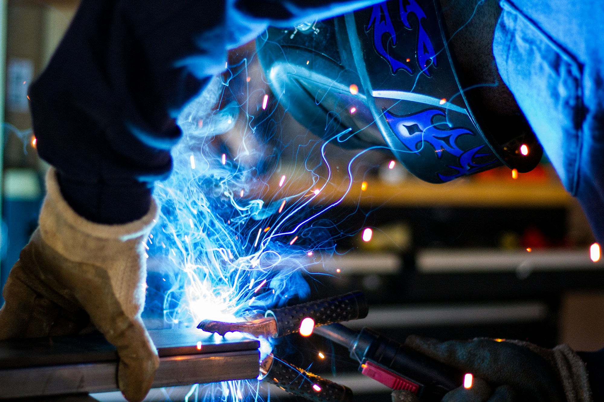 Welder joining metal with bright sparks